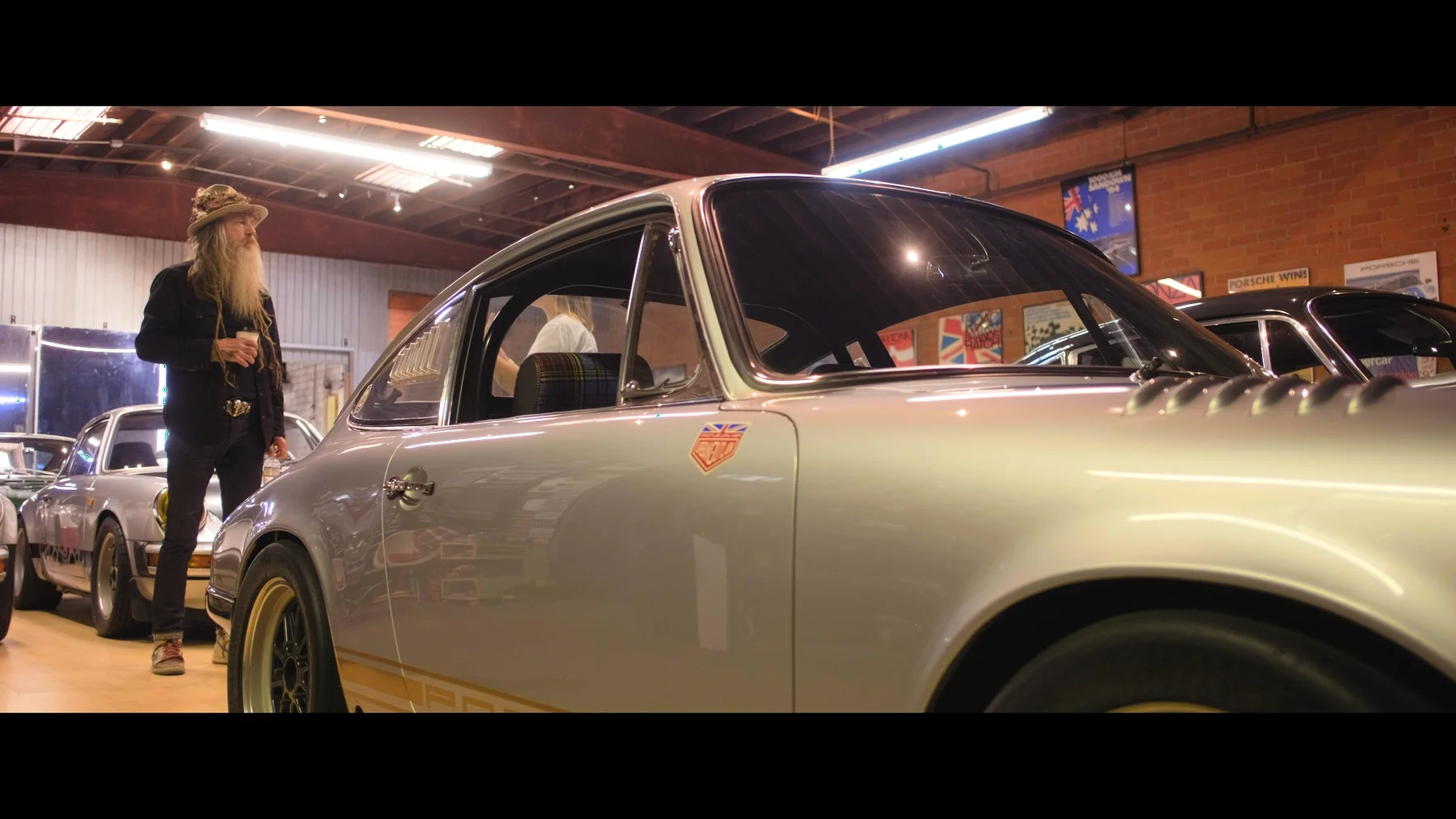 A classic car in a workshop — frame from the TCOS series