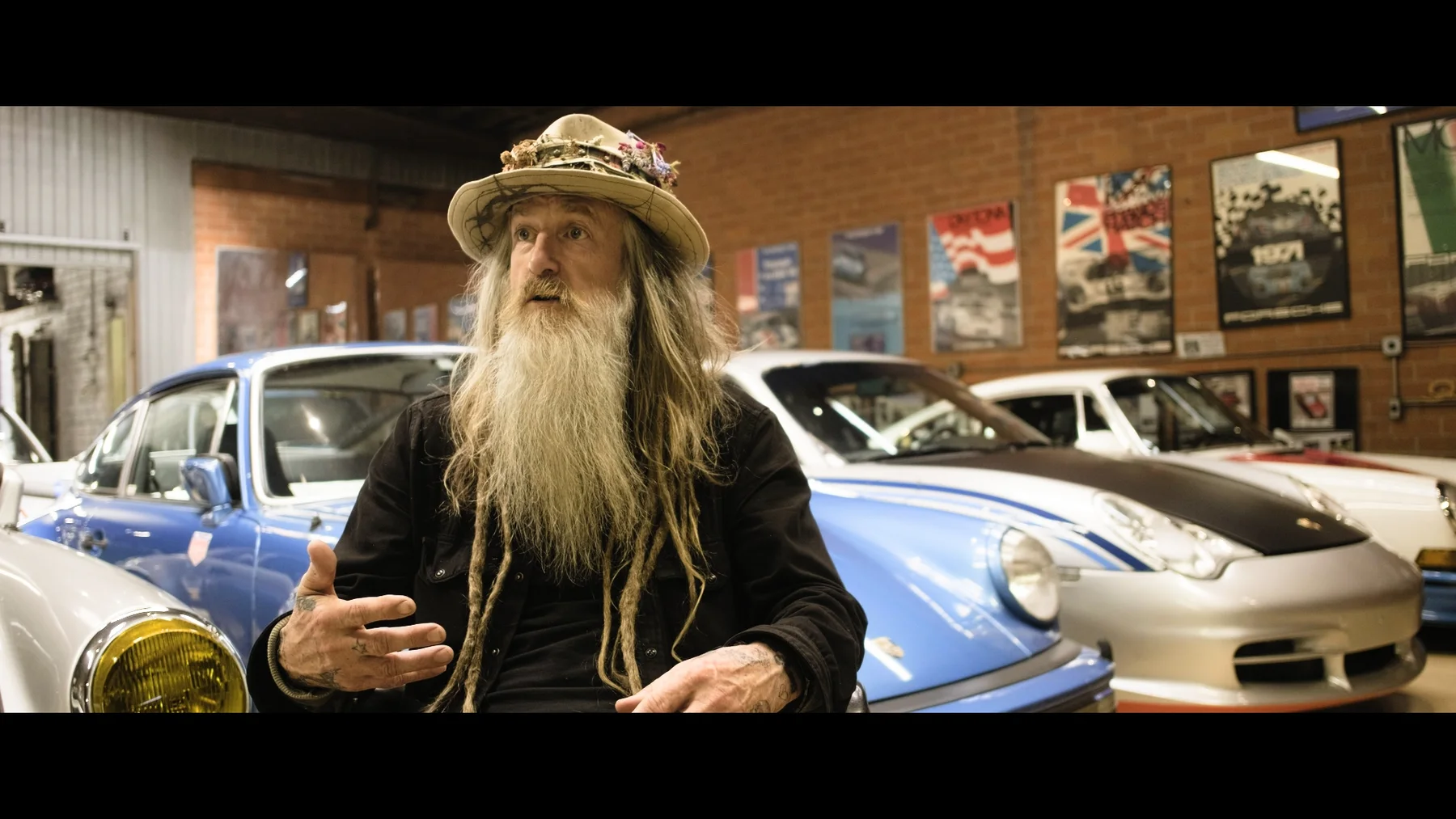 A protagonist in a collector's garage — frame from the TCOS series