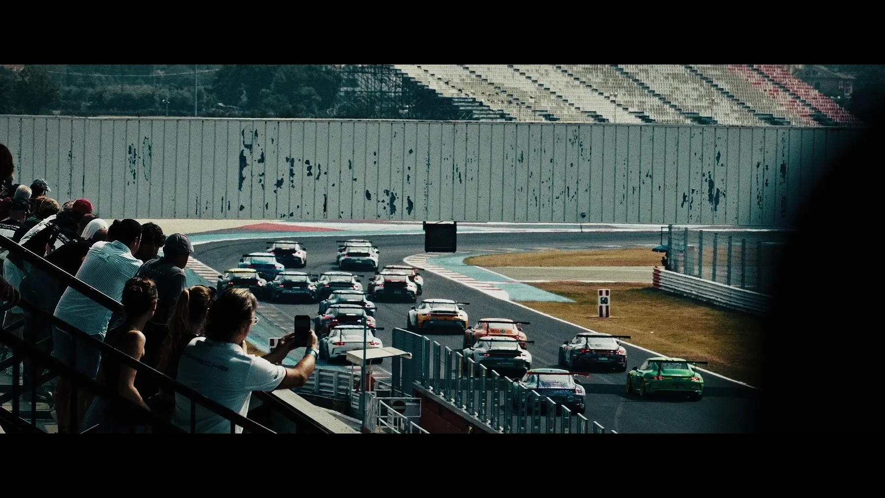 Cars lined up on a track — frame from the TCOS series